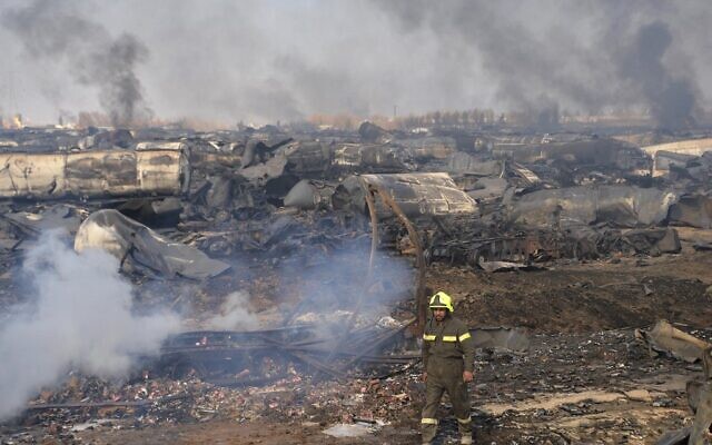 A firefighter walks amidst wreckage of gas tankers after a fire accident at Islam Qala on the outskirts of Herat, in the border between Afghanistan and Iran on February 14, 2021. (HOSHANG HASHIMI / AFP) A firefighter walks amidst wreckage of gas tankers after a fire accident at Islam Qala on the outskirts of Herat, in the border between Afghanistan and Iran on February 14, 2021. (HOSHANG HASHIMI / AFP)