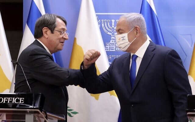 (L to R) Cyprus' President Nicos Anastasiades elbow-bumps Prime Minister Benjamin Netanyahu (mask-clad), during a joint press statement after their meeting at the Prime Minister's Office in Jerusalem on February 14, 2021. (Marc Israel SELLEM / POOL / AFP) (L to R) Cyprus' President Nicos Anastasiades elbow-bumps Prime Minister Benjamin Netanyahu (mask-clad), during a joint press statement after their meeting at the Prime Minister's Office in Jerusalem on February 14, 2021. (Marc Israel SELLEM / POOL / AFP)