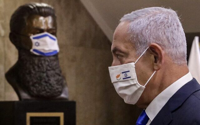 Prime Minister Benjamin Netanyahu at the Prime Minister's Office in Jerusalem on February 14, 2021, in front of a mask-clad bust of Theodor Herzl, the founder of modern Zionism. (Marc Israel Sellem/Pool/AFP) Prime Minister Benjamin Netanyahu at the Prime Minister's Office in Jerusalem on February 14, 2021, in front of a mask-clad bust of Theodor Herzl, the founder of modern Zionism. (Marc Israel Sellem/Pool/AFP)