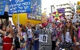 Israelis wearing costumes take part in a parade during the festivities of the Jewish holiday of Purim, while also protesting against Prime Minister Benjamin Netanyahu, on February 26, 2021 in Tel Aviv (JACK GUEZ / AFP)