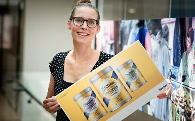 Renee Pater presents the design for the new label that her company, Patisserie Pater, produces in Zwaagdijk, the Netherlands. (Patisserie Pater/ via JTA)