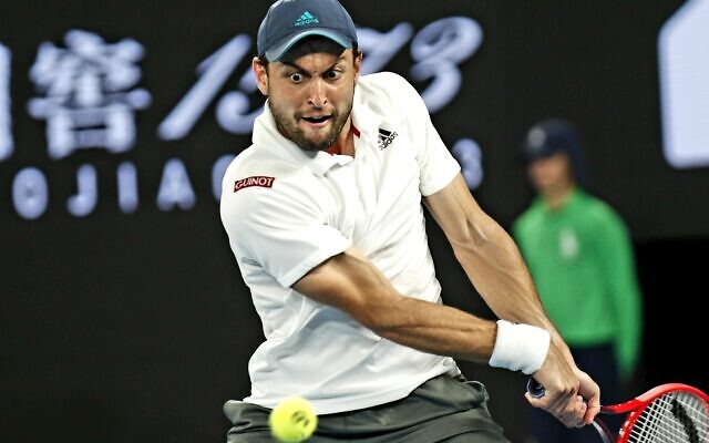 Aslan Karatsev returns a shot against Novak Djokovic at the Australian Open in Melbourne, Australia, Feb. 18, 2021 (Peter Haskin / Australian Jewish News) Aslan Karatsev returns a shot against Novak Djokovic at the Australian Open in Melbourne, Australia, Feb. 18, 2021 (Peter Haskin / Australian Jewish News)