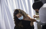 A woman receives a COVID-19 vaccine injection at Clalit COVID-19 vaccination center in Jerusalem, on February 8, 2021. (Olivier Fitoussi/ Flash90)