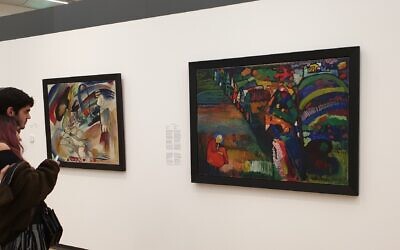 Tourists view a disputed Wassily Kandinsky painting at the Stedelijk Museum in Amsterdam, July 10, 2019. (Cnaan Liphshiz/JTA)