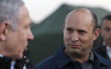 In this Sunday, November 24, 2019 photo, then-defense minister Naftali Bennett and Prime Minister Benjamin Netanyahu visit an Israeli military base in the Golan Heights, on the Israeli-Syrian border. (Atef Safadi/Pool via AP, File)