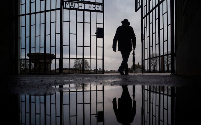Illustrative: A man walks through the gate of the Sachsenhausen Nazi death camp with the phrase 'Arbeit macht frei' (work sets you free) during International Holocaust Remembrance Day in Oranienburg, about 30 kilometers (18 miles), north of Berlin, Germany. (AP Photo/Markus Schreiber, file) Illustrative: A man walks through the gate of the Sachsenhausen Nazi death camp with the phrase 'Arbeit macht frei' (work sets you free) during International Holocaust Remembrance Day in Oranienburg, about 30 kilometers (18 miles), north of Berlin, Germany. (AP Photo/Markus Schreiber, file)