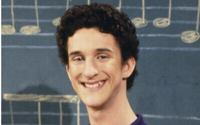 This image released by NBC shows actor Dustin Diamond as Samuel Powers, better known as Screech" from the 1990's series "Saved by the Bell." Diamond died Monday after a three-week fight with carcinoma, according to his representative. He was 44. Diamond was hospitalized last month in Florida and his team disclosed later he had cancer. (Paul Drinkwater/NBCU Photo Bank via AP)