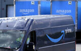 An Amazon Prime logo appears on the side of a delivery van as it departs an Amazon Warehouse location in Dedham, Massachusetts, October 1, 2020. (Steven Senne/AP)