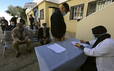 In this February 3, 2021, photo, a man registers to get the COVID-19 vaccine, in Algiers, Algeria. (AP/Fateh Guidoum)