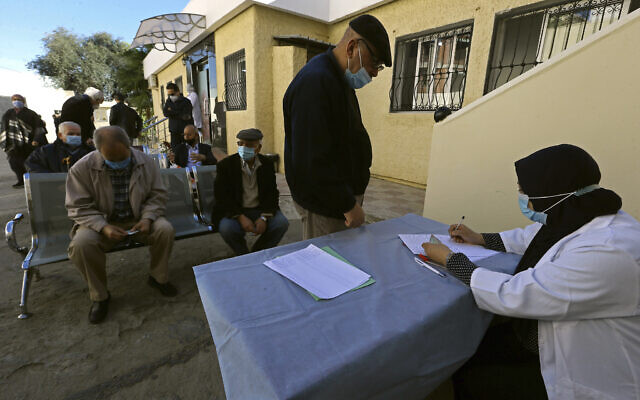 In this February 3, 2021, photo, a man registers to get the COVID-19 vaccine, in Algiers, Algeria. (AP/Fateh Guidoum) In this February 3, 2021, photo, a man registers to get the COVID-19 vaccine, in Algiers, Algeria. (AP/Fateh Guidoum)