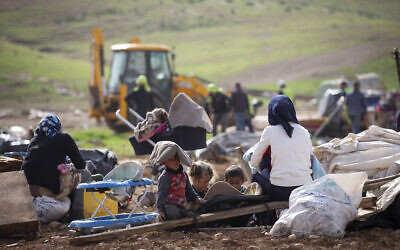 In this Feb. 3, 2021, file, photo, Palestinian Bedouin watch Israeli troops demolish tents and other structures of the Khirbet Humsu hamlet in the Jordan Valley in the West Bank (AP Photo/Majdi Mohammed)