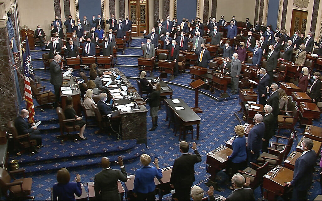 In this image from video, Sen. Patrick Leahy, Democrat-Vermont, the president pro tempore of the Senate, who is presiding over the impeachment of former US President Donald Trump, swears in members of the Senate for the trial at the US Capitol in Washington, January 26, 2021. (Senate Television via AP) In this image from video, Sen. Patrick Leahy, Democrat-Vermont, the president pro tempore of the Senate, who is presiding over the impeachment of former US President Donald Trump, swears in members of the Senate for the trial at the US Capitol in Washington, January 26, 2021. (Senate Television via AP)