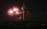Fireworks explode next to Milad telecommunications tower during celebrations marking the 42nd anniversary of Iran's Islamic Revolution, in Tehran, Iran, February 9, 2021. (Vahid Salemi/AP)