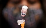 Illustrative: A medical assistant prepares a dose of the Pfizer-BioNTech COVID-19 vaccine at a vaccination center at the University of Nevada, Las Vegas, January 22, 2021. (AP Photo/John Locher, File)