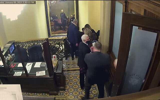 In this image from video, a security video shows Vice President Mike Pence being evacuated as rioters breach the Capitol, as House impeachment manager Del. Stacey Plaskett, D-Virgin Islands, speaks during the second impeachment trial of former President Donald Trump in the Senate at the US Capitol in Washington, Wednesday, Feb. 10, 2021. (Senate Television via AP) In this image from video, a security video shows Vice President Mike Pence being evacuated as rioters breach the Capitol, as House impeachment manager Del. Stacey Plaskett, D-Virgin Islands, speaks during the second impeachment trial of former President Donald Trump in the Senate at the US Capitol in Washington, Wednesday, Feb. 10, 2021. (Senate Television via AP)