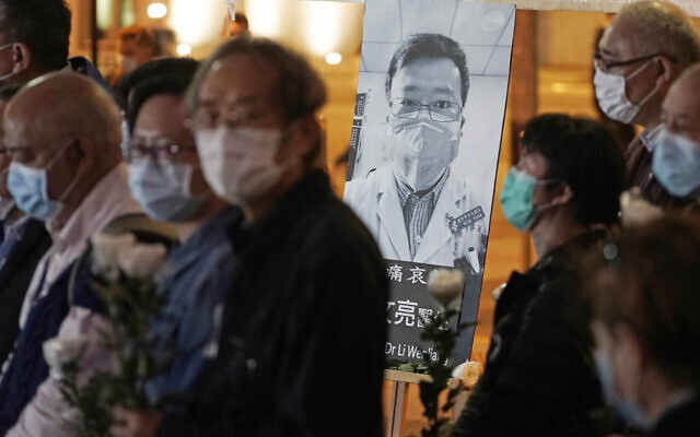 In this Feb. 7, 2020 file photo, people wearing masks attend a vigil for Chinese doctor Li Wenliang, in Hong Kong. The outpouring of grief and rage sparked by Li's death was an unusual - and for the Chinese Communist Party, unsettling - display in China's tightly monitored civic space. (AP Photo/Kin Cheung, File) In this Feb. 7, 2020 file photo, people wearing masks attend a vigil for Chinese doctor Li Wenliang, in Hong Kong. The outpouring of grief and rage sparked by Li's death was an unusual - and for the Chinese Communist Party, unsettling - display in China's tightly monitored civic space. (AP Photo/Kin Cheung, File)