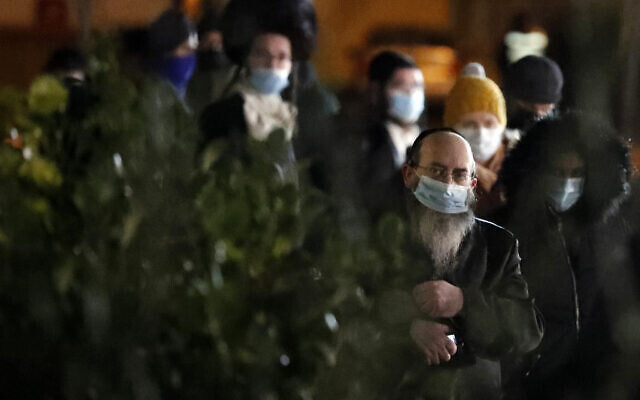 People from the Haredi Orthodox Jewish community arrive at an event to encourage vaccine uptake in the ultra-Orthodox community at the John Scott Vaccination Centre in London, Saturday, Feb. 13, 2021 (AP Photo/Frank Augstein)