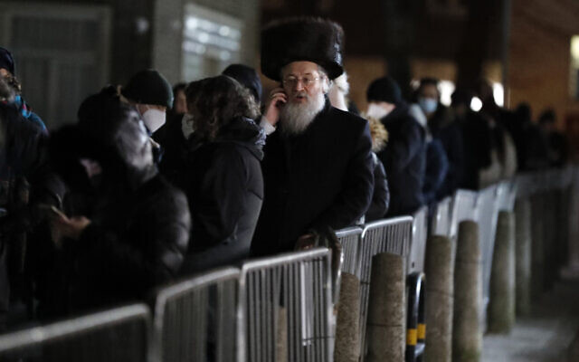 People from the Haredi Orthodox Jewish community arrive at an event to encourage vaccine uptake in the ultra-Orthodox community at the John Scott Vaccination Centre in London, Saturday, Feb. 13, 2021 (AP Photo/Frank Augstein)