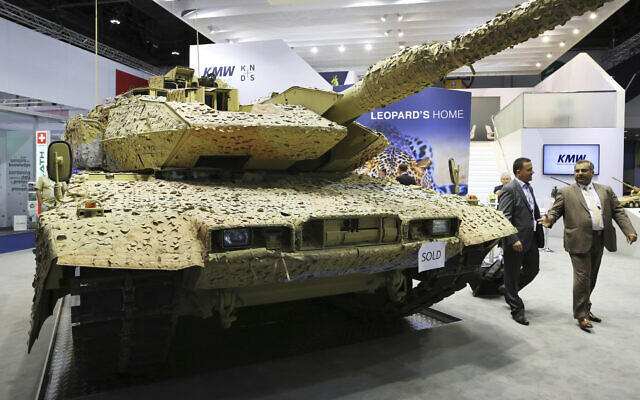 Illustrative: Men walk past a Krauss-Maffei Wegmann Leopard tank with a "sold" sign on it at the International Defense Exhibition and Conference, known by the acronym IDEX, in Abu Dhabi, United Arab Emirates, February 22, 2017 (AP Photo/Jon Gambrell, File) Illustrative: Men walk past a Krauss-Maffei Wegmann Leopard tank with a "sold" sign on it at the International Defense Exhibition and Conference, known by the acronym IDEX, in Abu Dhabi, United Arab Emirates, February 22, 2017 (AP Photo/Jon Gambrell, File)