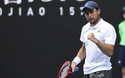 Aslan Karatsev celebrates after defeating Bulgaria's Grigor Dimitrov in their quarterfinal match at the Australian Open tennis championship in Melbourne, Australia, Feb. 16, 2021.(AP Photo/Hamish Blair)