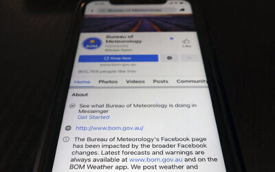 A disclaimer is shown on the bottom of Australia's Bureau of Meteorology page on the Facebook app, February 18, 2021, in Tokyo. (AP Photo/Kiichiro Sato)