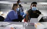 Tyson Foods team members receive COVID-19 vaccines from health officials at the Joslin, Illinois facility, February 19, 2021. (John Konstantaras/AP Images for Tyson Foods)