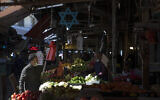 Israelis shop at a market in Tel Aviv, Israel, Sunday, Feb. 21, 2021. Israel lifted many of its coronavirus restrictions and started reopening its economy Sunday as the country's vaccination drive and third nationwide lockdown have started to bring down infections. (AP Photo/Sebastian Scheiner)