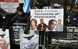 Illustrative: In this March 15, 2018, file photo, Uighurs and their supporters rally across the street from United Nations headquarters in New York. Members of the Uighur Muslim ethnic group are calling on China to post videos of their relatives who have disappeared into a vast system of internment camps. The campaign follows the release of a state media video showing famed Uighur musician Abdurehim Heyit, who many believed had died in custody. (AP Photo/Seth Wenig, File)
