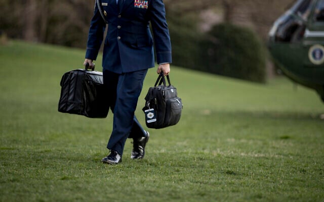 Illustrative -- A US military aide carries the 'president's emergency satchel,' also know as 'the football,' with the nuclear launch codes, across the South Lawn of the White House in Washington, March 31, 2019 (AP/Andrew Harnik) Illustrative -- A US military aide carries the 'president's emergency satchel,' also know as 'the football,' with the nuclear launch codes, across the South Lawn of the White House in Washington, March 31, 2019 (AP/Andrew Harnik)