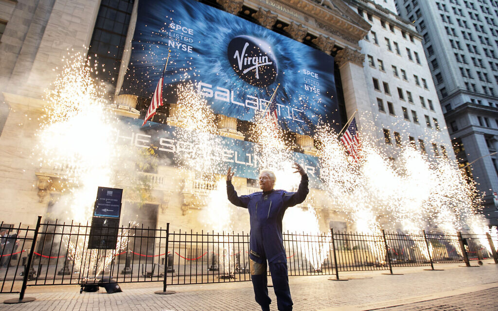 Sir Richard Branson, founder of Virgin Galactic, poses for a photo outside the New York Stock Exchange as fireworks are exploded before his company's IPO, performed via a reverse merger with a SPAC, on Monday, Oct. 28, 2019. (AP/Richard Drew) Sir Richard Branson, founder of Virgin Galactic, poses for a photo outside the New York Stock Exchange as fireworks are exploded before his company's IPO, performed via a reverse merger with a SPAC, on Monday, Oct. 28, 2019. (AP/Richard Drew)