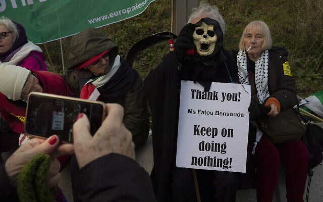 A woman takes a picture of the Grim Reaper holding a sign referring to Chief Prosecutor Fatou Bensouda during a demonstration outside the International Criminal Court, ICC, urging the court to prosecute Israel's army for war crimes in The Hague, Netherlands, Friday, Nov. 29, 2019. (AP/Peter Dejong) A woman takes a picture of the Grim Reaper holding a sign referring to Chief Prosecutor Fatou Bensouda during a demonstration outside the International Criminal Court, ICC, urging the court to prosecute Israel's army for war crimes in The Hague, Netherlands, Friday, Nov. 29, 2019. (AP/Peter Dejong)