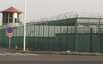 In this Dec. 3, 2018, photo, a guard tower and barbed wire fence surround a detention facility in the Kunshan Industrial Park in Artux in western China's Xinjiang region. (AP Photo/Ng Han Guan)