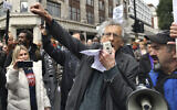 The brother of former Labour leader Jeremy Corbyn, Piers Corbyn, gestures during a coronavirus anti-lockdown rally on Oxford Street, in London, Saturday, Oct. 17, 2020. (Dominic Lipinski/PA via AP)