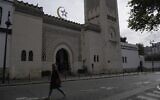 A woman walks outside the Paris mosque, October 29, 2020. (AP Photo/Thibault Camus)