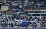 Illustrative: Passengers queue to get on buses in the capital Addis Ababa, Ethiopia, Nov. 6, 2020. (AP/Mulugeta Ayene)