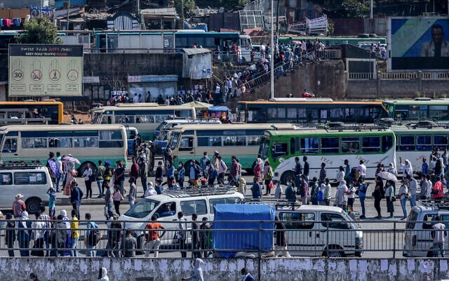 Illustrative: Passengers queue to get on buses in the capital Addis Ababa, Ethiopia, Nov. 6, 2020. (AP/Mulugeta Ayene) Illustrative: Passengers queue to get on buses in the capital Addis Ababa, Ethiopia, Nov. 6, 2020. (AP/Mulugeta Ayene)