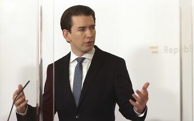 Austrian Chancellor Sebastian Kurz speaks behind plexiglass shields at a press conference at the federal chancellery in Vienna, Austria, Sunday, Jan. 17, 2021 (AP Photo/Ronald Zak)