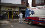 Illustrative: Paramedic Clive Maleso stands next to a Saaberie Chishty ambulance before transferring a COVID-19 patient from his home to the hospital in Lenasia, South Africa, Thursday, Jan. 7, 2021 (AP Photo/Bram Janssen)