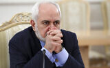 In this photo released by the Russian Foreign Ministry Press Service, Iranian Foreign Minister Mohammad Javad Zarif listens to Russian Foreign Minister Sergey Lavrov during the talks in Moscow, Russia, Tuesday, Jan. 26, 2021. (Russian Foreign Ministry Press Service via AP)