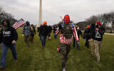In this January 6, 2021 photo, people march with those who say they are members of the Proud Boys as they attend a rally in Washington, DC in support of then-US president Donald Trump. (AP Photo/Carolyn Kaster)
