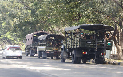Soldiers sit inside trucks parked on a road in Naypyitaw, Myanmar, February 1, 2021. (AP Photo)
