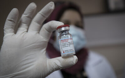 Illustrative: A Palestinian medic displays a vial of the Moderna COVID-19 vaccine in the West Bank city of Bethlehem, February 3, 2021, as the Palestinian Authority began administering coronavirus vaccinations after receiving several thousands of doses of the Moderna vaccine from Israel. (AP Photo/Nasser Nasser)