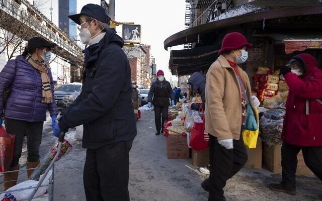 Shoppers walk with their purchases, Monday, Feb. 8, 2021, in the Chinatown neighborhood of New York. (AP Photo/Mark Lennihan) Shoppers walk with their purchases, Monday, Feb. 8, 2021, in the Chinatown neighborhood of New York. (AP Photo/Mark Lennihan)
