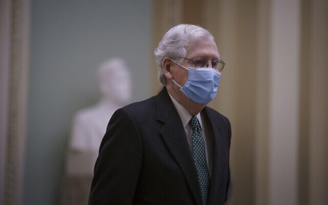US Senate Minority Leader Mitch McConnell returns to the chamber from a short break in the Senate trial of former President Donald Trump, at the Capitol in Washington, Thursday, Feb. 11, 2021. (AP Photo/J. Scott Applewhite) US Senate Minority Leader Mitch McConnell returns to the chamber from a short break in the Senate trial of former President Donald Trump, at the Capitol in Washington, Thursday, Feb. 11, 2021. (AP Photo/J. Scott Applewhite)