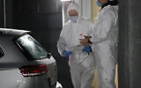 Danish forensic technicians work at Apotekerhaven in Holbaek, Denmark, on February 6, 2021, as Danish police search addresses in Apotekerhaven. (presse-fotos.dk/Ritzau via AP)