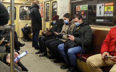 People wearing face masks to prevent the spread of the coronavirus ride in a subway train in Kyiv, Ukraine on Feb. 12, 2021. (AP Photo/Efrem Lukatsky)