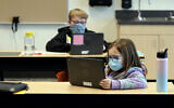 In this February 2, 2021, file photo, students wear masks as they work in a fourth-grade classroom, at Elk Ridge Elementary School in Buckley, Washington. (AP Photo/Ted S. Warren, File)