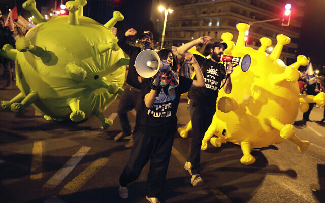Protesters chant slogans during a demonstration against Prime Minister Benjamin Netanyahu in Jerusalem, Saturday, Feb. 13, 2021. (AP Photo/Sebastian Scheiner) Protesters chant slogans during a demonstration against Prime Minister Benjamin Netanyahu in Jerusalem, Saturday, Feb. 13, 2021. (AP Photo/Sebastian Scheiner)