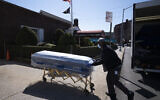 In this March 27, 2020 file photo, William Samuels delivers caskets to the Gerard Neufeld Funeral Home during the coronavirus pandemic in the Queens borough of New York (AP Photo/Mark Lennihan)