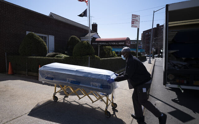 In this March 27, 2020 file photo, William Samuels delivers caskets to the Gerard Neufeld Funeral Home during the coronavirus pandemic in the Queens borough of New York (AP Photo/Mark Lennihan) In this March 27, 2020 file photo, William Samuels delivers caskets to the Gerard Neufeld Funeral Home during the coronavirus pandemic in the Queens borough of New York (AP Photo/Mark Lennihan)